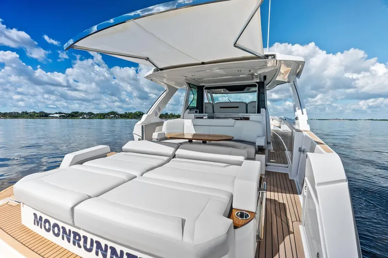 Moonrunner Yacht Photos Pics 2024 Tiara Yachts 48 LS luxury yacht with spacious deck and seating, cruising on calm waters.