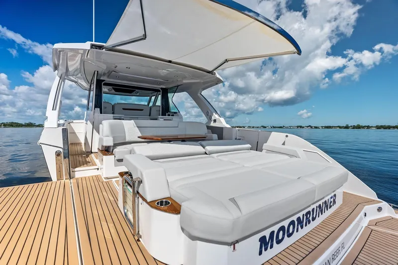 Moonrunner Yacht Photos Pics 2024 Tiara Yachts 48 LS luxury yacht with spacious deck and seating, under clear blue sky.