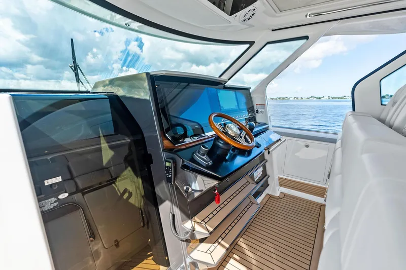 Moonrunner Yacht Photos Pics 2024 Tiara Yachts 48 LS helm with modern controls and panoramic water view.