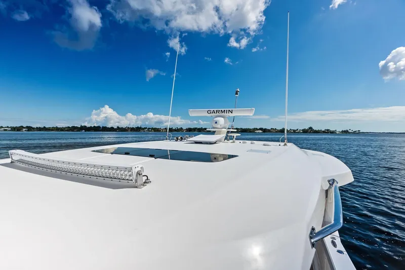 Moonrunner Yacht Photos Pics 2024 Tiara Yachts 48 LS on open water under clear blue sky.