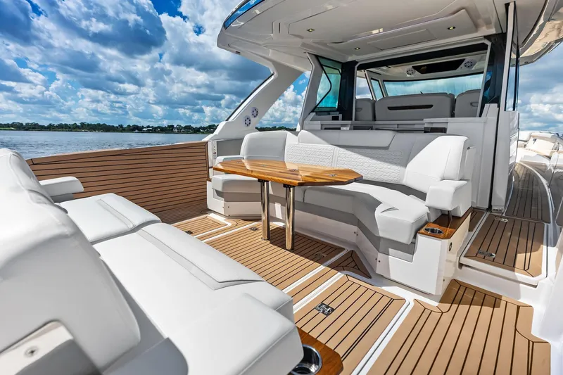 Moonrunner Yacht Photos Pics 2024 Tiara Yachts 48 LS luxury yacht interior with elegant seating and wooden accents.