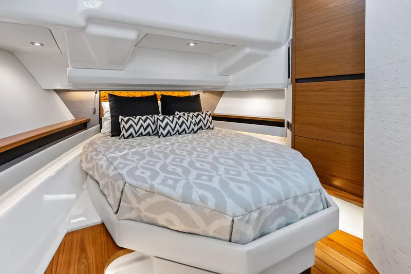 Moonrunner Yacht Photos Pics Luxurious cabin interior of 2024 Tiara Yachts 48 LS with elegant bedding and wood accents.
