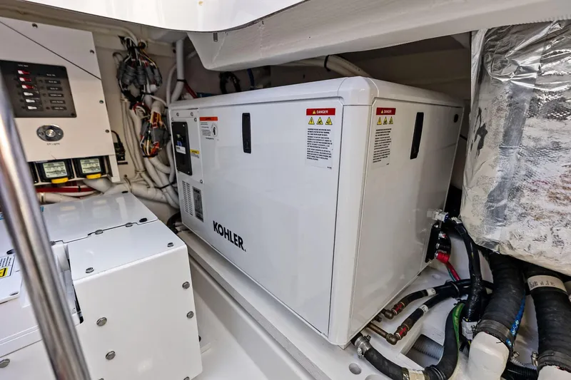 Moonrunner Yacht Photos Pics Engine room of 2024 Tiara Yachts 48 LS featuring Kohler generator and electrical components.