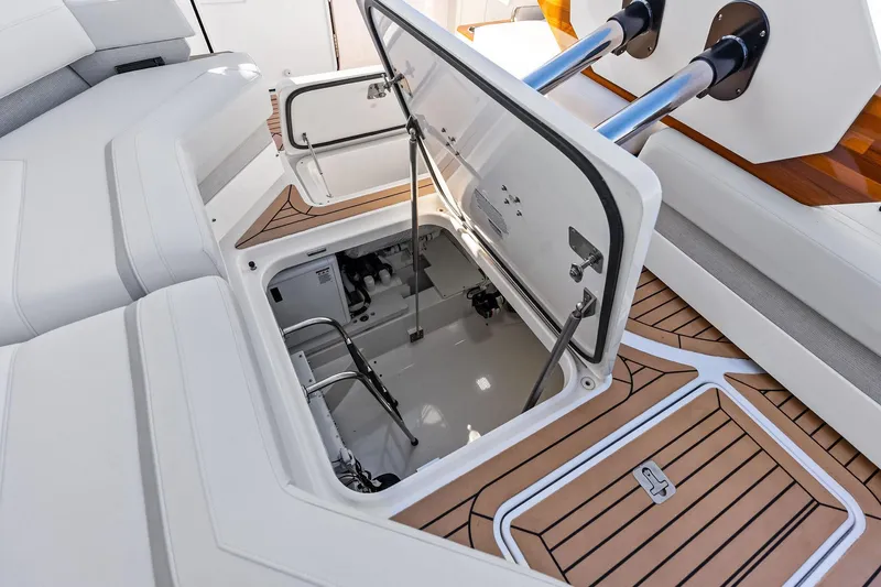 Moonrunner Yacht Photos Pics 2024 Tiara Yachts 48 LS engine compartment with open hatch, showcasing interior details.