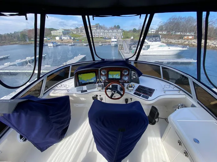  Yacht Photos Pics 2005 Sea Ray 420 Sedan Bridge helm with marina view, featuring modern navigation equipment.