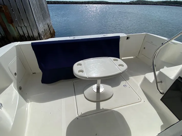  Yacht Photos Pics 2005 Sea Ray 420 Sedan Bridge yacht deck with table, overlooking serene water.