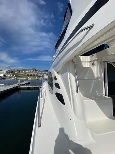  Yacht Photos Pics 2005 Sea Ray 420 Sedan Bridge yacht docked under a clear blue sky.