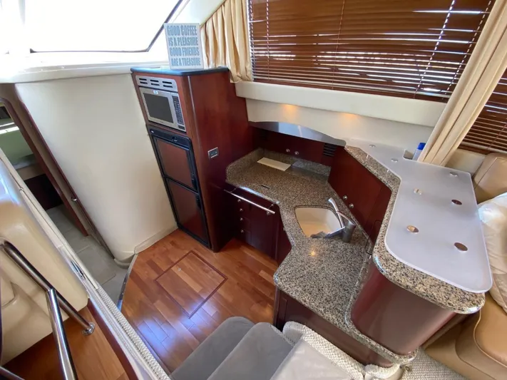  Yacht Photos Pics Interior of 2005 Sea Ray 420 Sedan Bridge with modern kitchen and wood flooring.
