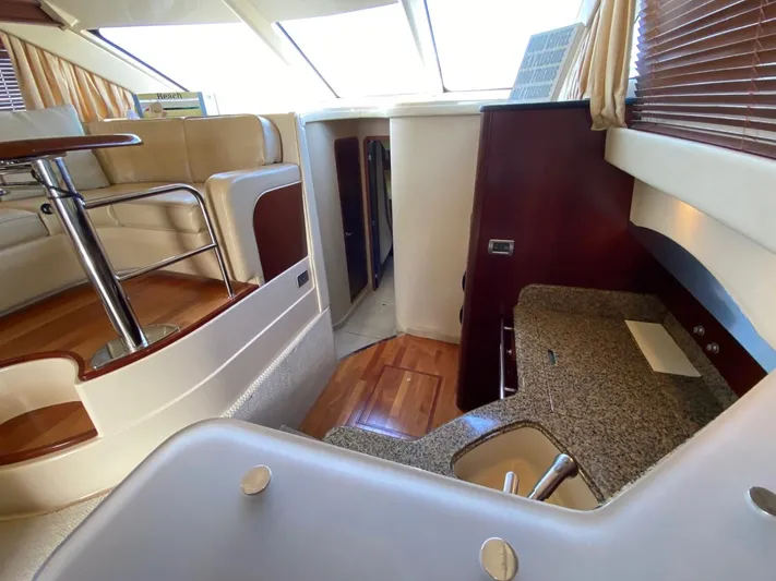  Yacht Photos Pics Interior of 2005 Sea Ray 420 Sedan Bridge yacht with modern seating and kitchenette.