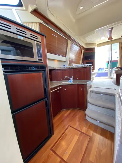  Yacht Photos Pics Interior of 2005 Sea Ray 420 Sedan Bridge with wood flooring and modern kitchen amenities.