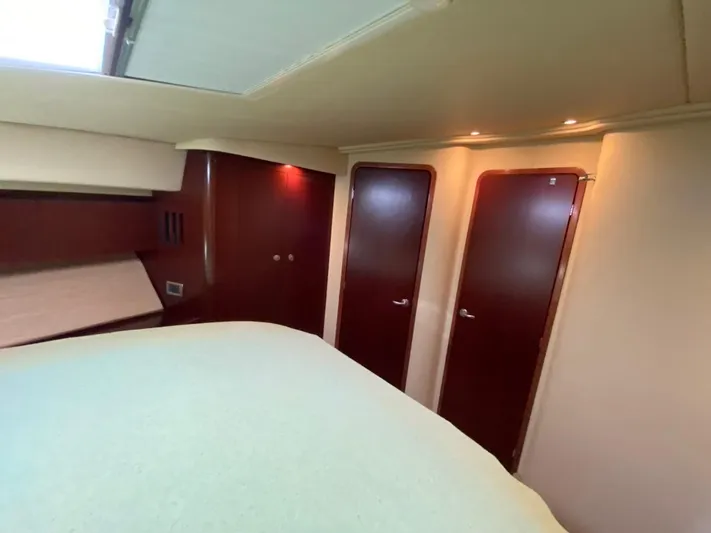  Yacht Photos Pics Interior of 2005 Sea Ray 420 Sedan Bridge with wooden doors and soft lighting.