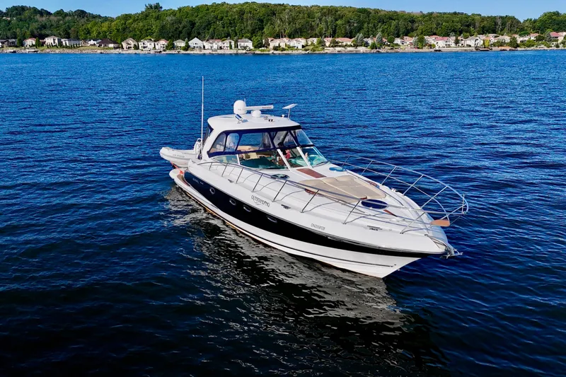 Outstanding Yacht Photos Pics 2007 Doral Alegria yacht cruising on a serene lake with a forested shoreline.