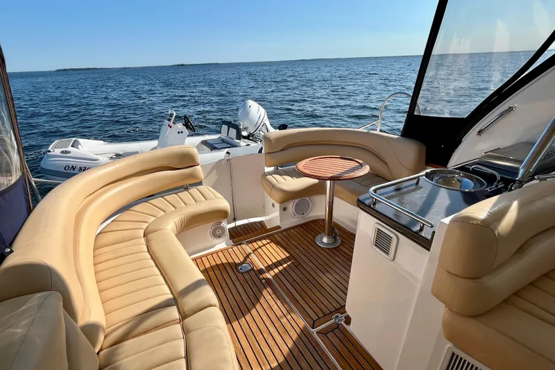 Outstanding Yacht Photos Pics 2007 Doral Alegria yacht interior with tan seating, wooden deck, and ocean view.