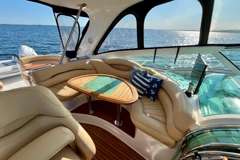 Outstanding Yacht Photos Pics 2007 Doral Alegria yacht interior with plush seating, wooden table, and ocean view.