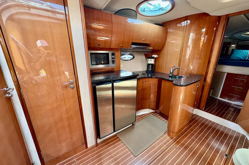 Outstanding Yacht Photos Pics Luxurious 2007 Doral Alegria yacht interior with modern kitchen and wood finish.