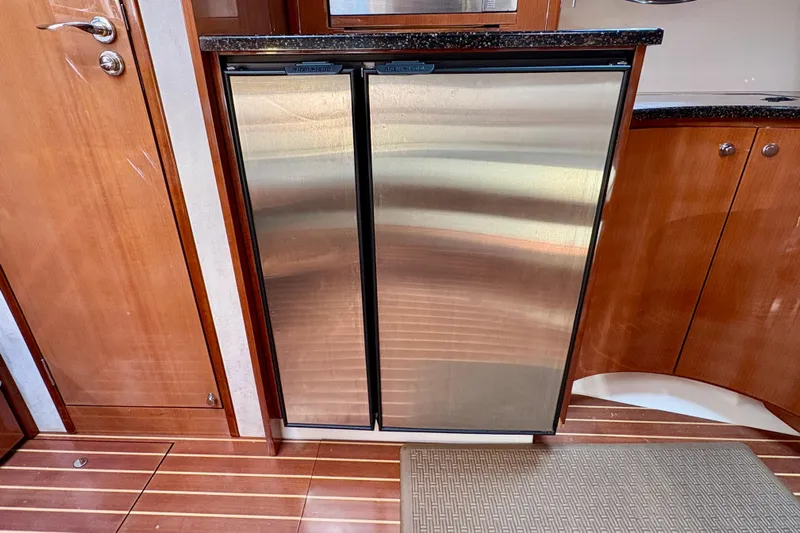 Outstanding Yacht Photos Pics Stainless steel refrigerator in 2007 Doral Alegria yacht kitchen with wooden cabinetry.