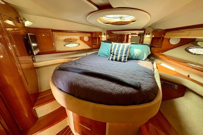 Outstanding Yacht Photos Pics Luxurious 2007 Doral Alegria yacht bedroom with elegant wood finish and cozy bedding.