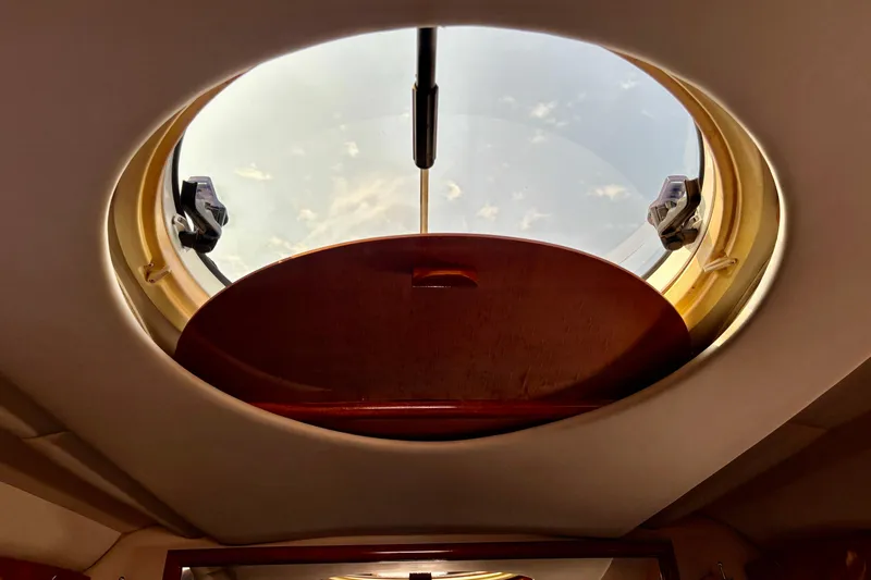 Outstanding Yacht Photos Pics Circular hatch view inside 2007 Doral Alegria boat, showcasing sky and sunlight.