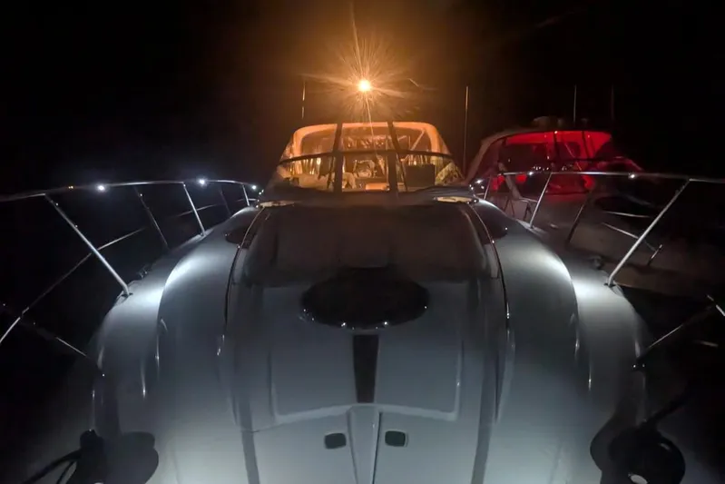 Outstanding Yacht Photos Pics 2007 Doral Alegria yacht illuminated at night, showcasing sleek design and vibrant lighting.