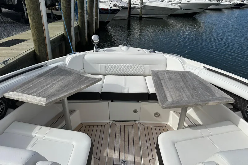  Yacht Photos Pics 2019 Sea Ray SLX 350 Outboard interior with dual tables and white seating at marina.