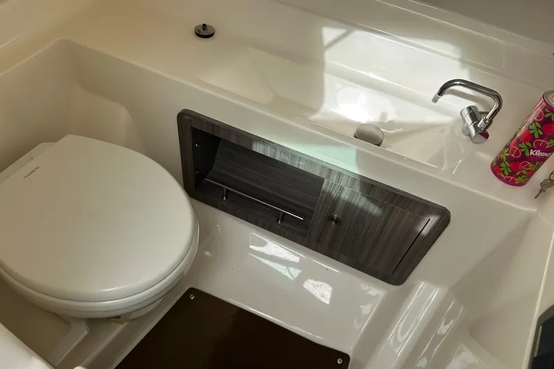  Yacht Photos Pics 2019 Sea Ray SLX 350 Outboard bathroom with toilet, sink, and storage cabinet.