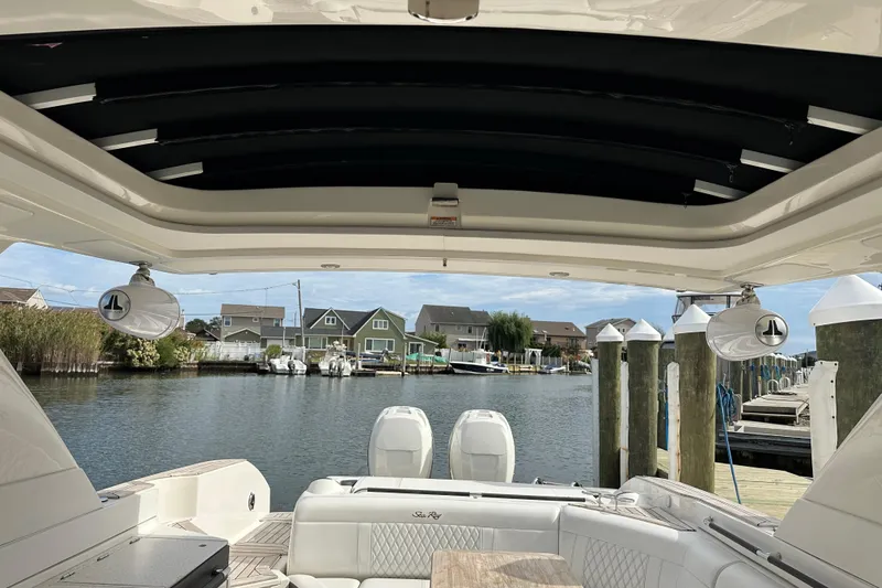  Yacht Photos Pics 2019 Sea Ray SLX 350 Outboard boat interior with waterfront view and docked houses.