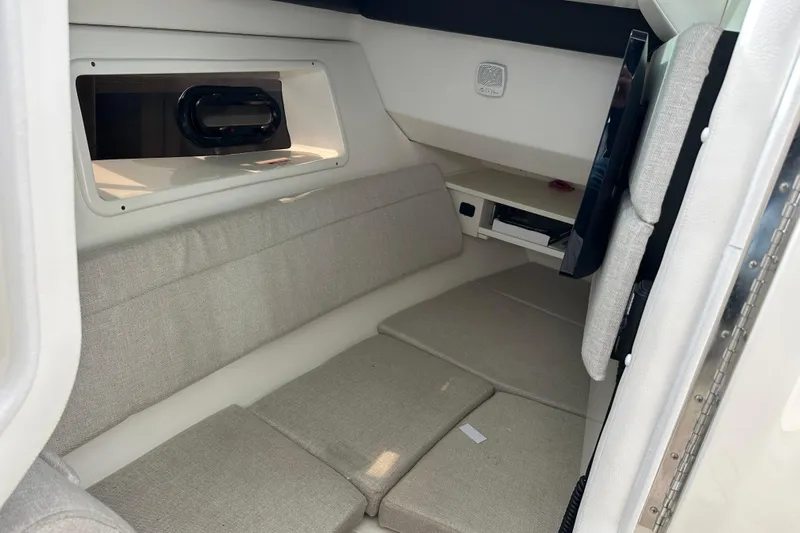  Yacht Photos Pics 2019 Sea Ray SLX 350 Outboard cabin interior with beige seating and window.