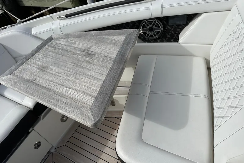  Yacht Photos Pics 2019 Sea Ray SLX 350 Outboard interior with wooden table and white seating.