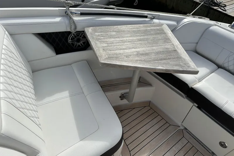  Yacht Photos Pics Luxurious seating area on 2019 Sea Ray SLX 350 Outboard with wooden table and white upholstery.