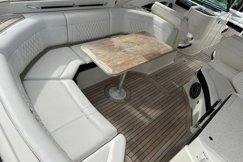  Yacht Photos Pics 2019 Sea Ray SLX 350 Outboard interior with elegant seating and wooden table.