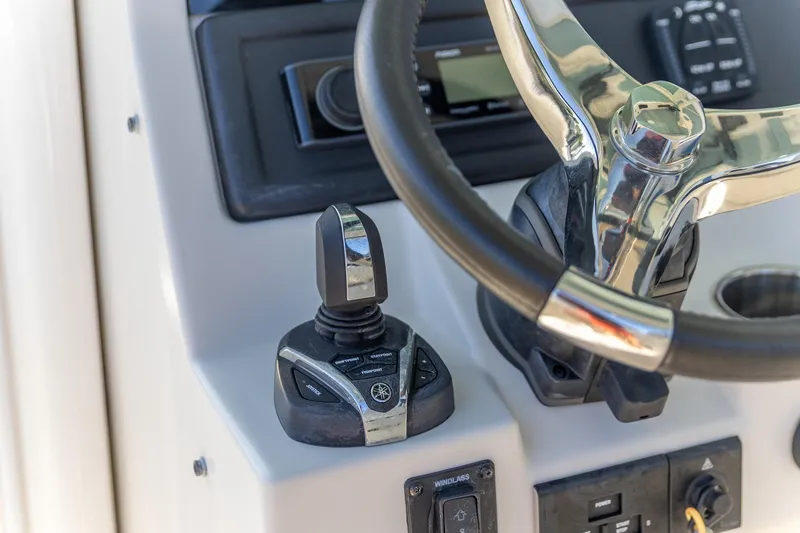  Yacht Photos Pics 2022 Sailfish 272 CC boat steering wheel and control panel close-up.