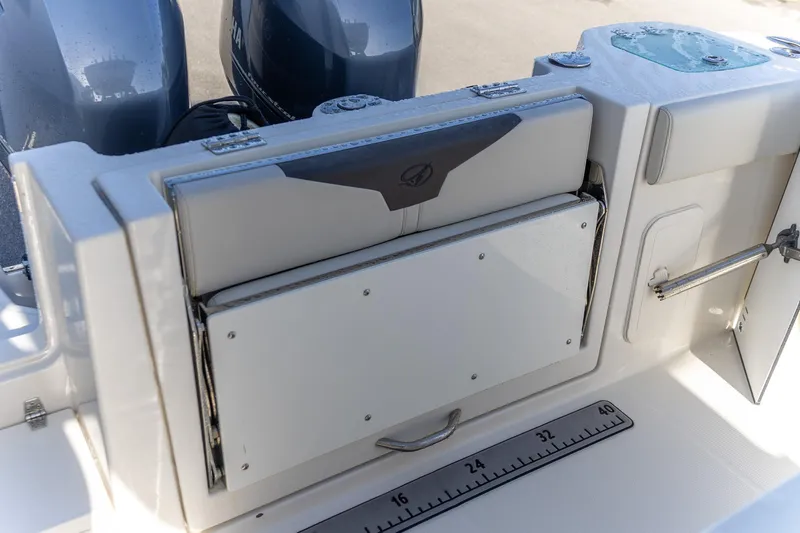  Yacht Photos Pics 2022 Sailfish 272 CC boat with foldable seat and measuring ruler on deck.