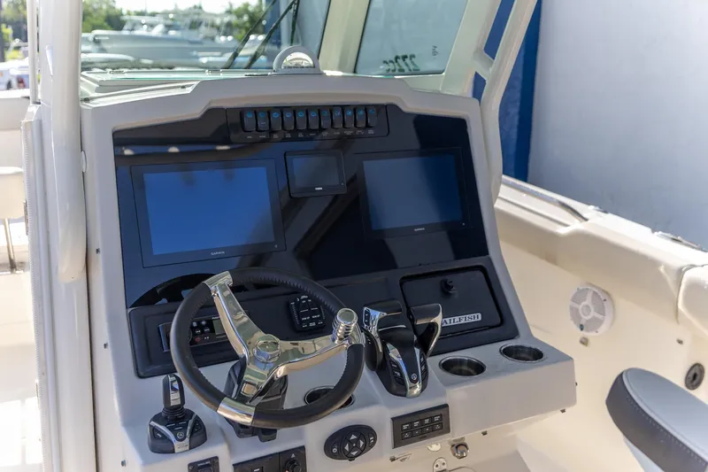  Yacht Photos Pics 2022 Sailfish 272 CC boat dashboard with steering wheel and electronic displays.