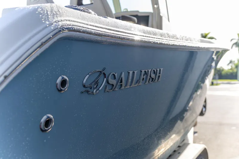  Yacht Photos Pics 2022 Sailfish 272 CC boat with sleek blue exterior and logo detail.
