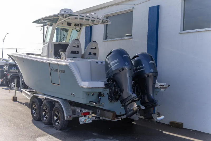  Yacht Photos Pics 2022 Sailfish 272 CC boat with dual Yamaha engines on a trailer.