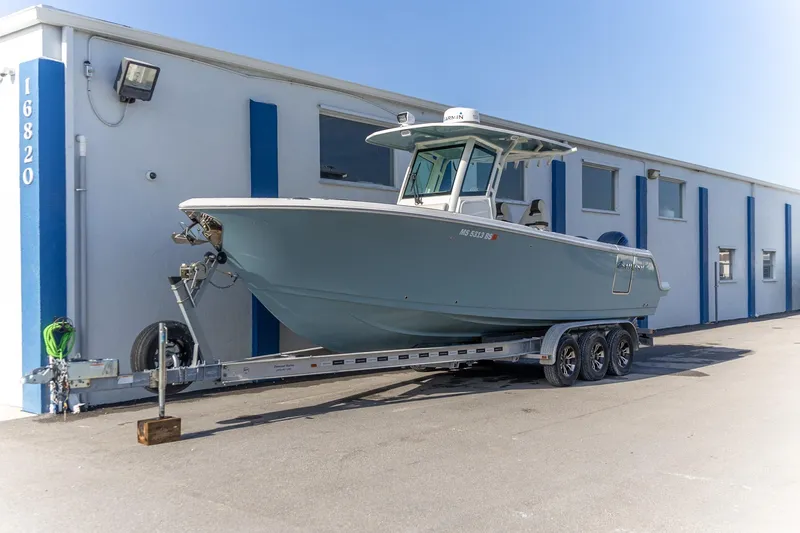  Yacht Photos Pics 2022 Sailfish 272 CC boat on trailer outside a building.