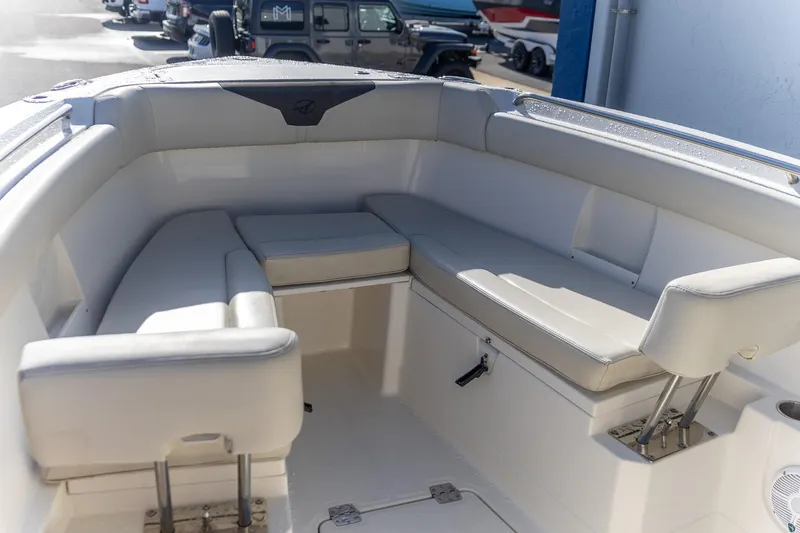  Yacht Photos Pics 2022 Sailfish 272 CC boat interior with cushioned seating and storage compartments.