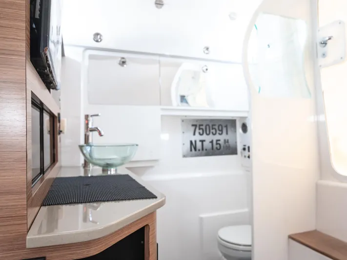 More Life Yacht Photos Pics Interior of 2020 Everglades 435 Center Console boat, featuring modern bathroom amenities.