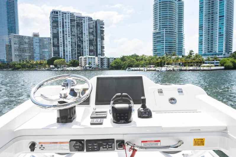 More Life Yacht Photos Pics Center console of 2020 Everglades 435 boat with city skyline in background.