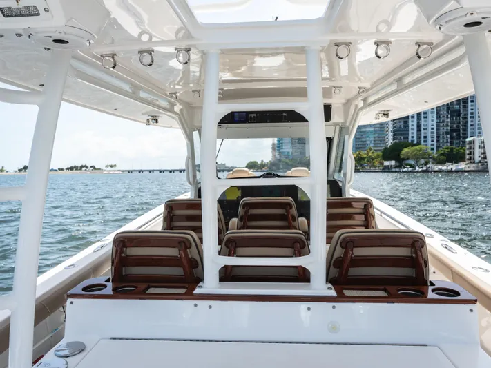 More Life Yacht Photos Pics 2020 Everglades 435 Center Console boat interior with seating, on a sunny day.