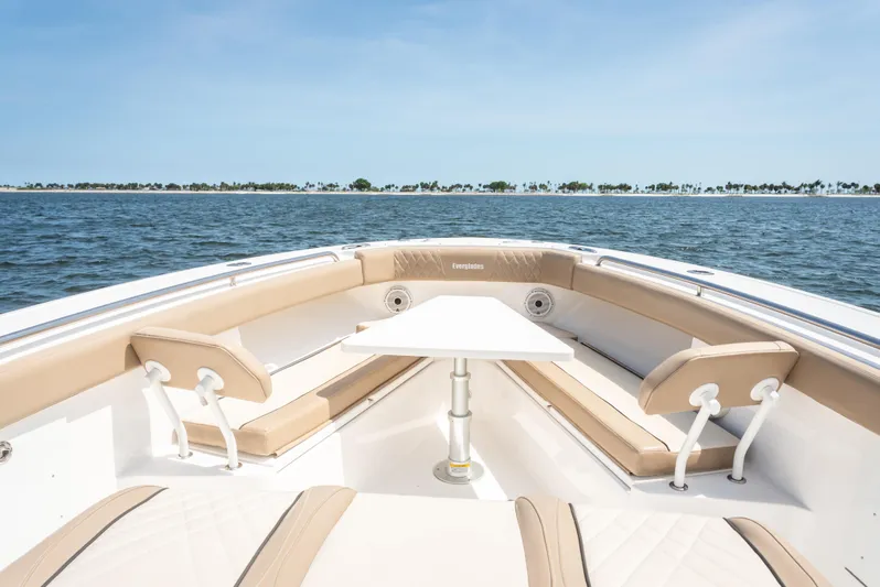 More Life Yacht Photos Pics 2020 Everglades 435 Center Console boat interior with seating and table on open water.