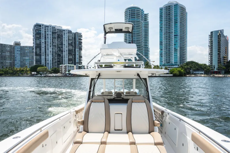 More Life Yacht Photos Pics 2020 Everglades 435 Center Console boat cruising near modern city skyline.