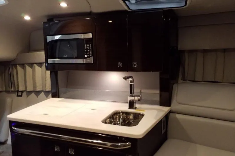 Yacht Photos Pics 2021 Formula 350 Sun Sport interior with kitchenette, featuring a microwave and sink.