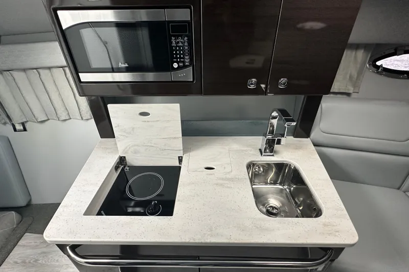  Yacht Photos Pics Modern kitchenette in 2021 Formula 350 Sun Sport with microwave, stove, and sink.