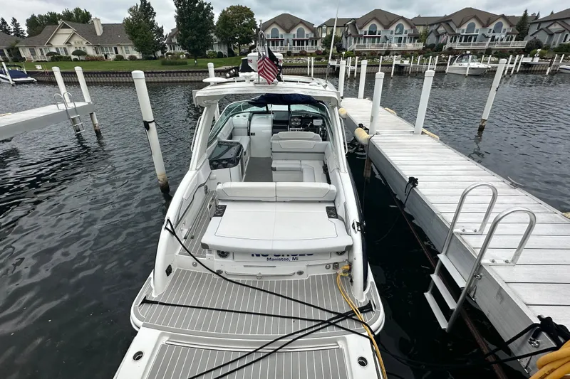  Yacht Photos Pics 2021 Formula 350 Sun Sport docked at marina, surrounded by waterfront homes.