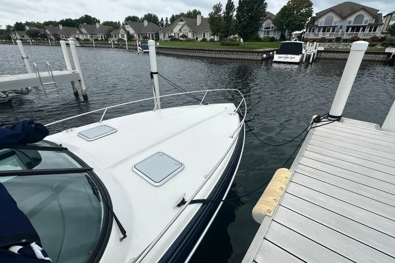  Yacht Photos Pics 2021 Formula 350 Sun Sport docked at a marina with waterfront homes.