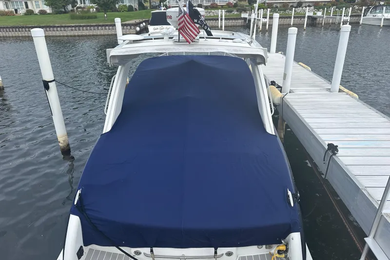  Yacht Photos Pics 2021 Formula 350 Sun Sport boat docked with blue cover, American flag displayed.