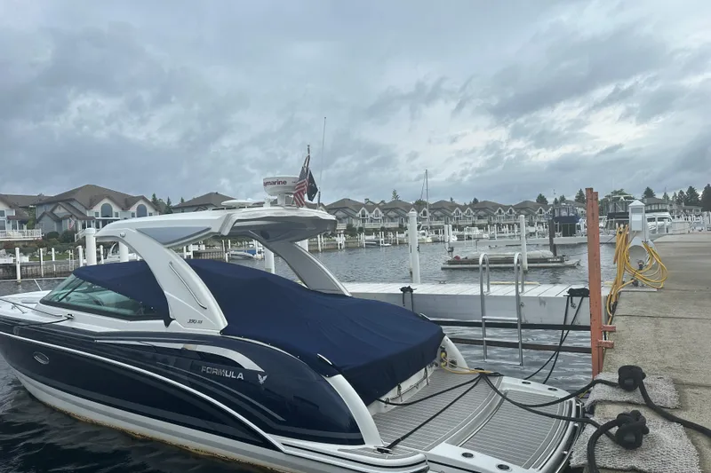  Yacht Photos Pics 2021 Formula 350 Sun Sport boat docked at marina with overcast sky.