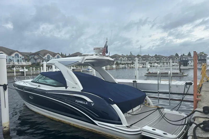  Yacht Photos Pics 2021 Formula 350 Sun Sport boat docked at a marina under cloudy skies.