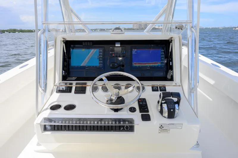 39z Yacht Photos Pics 2017 SeaVee 390 boat helm with dual screens and steering wheel on open water.